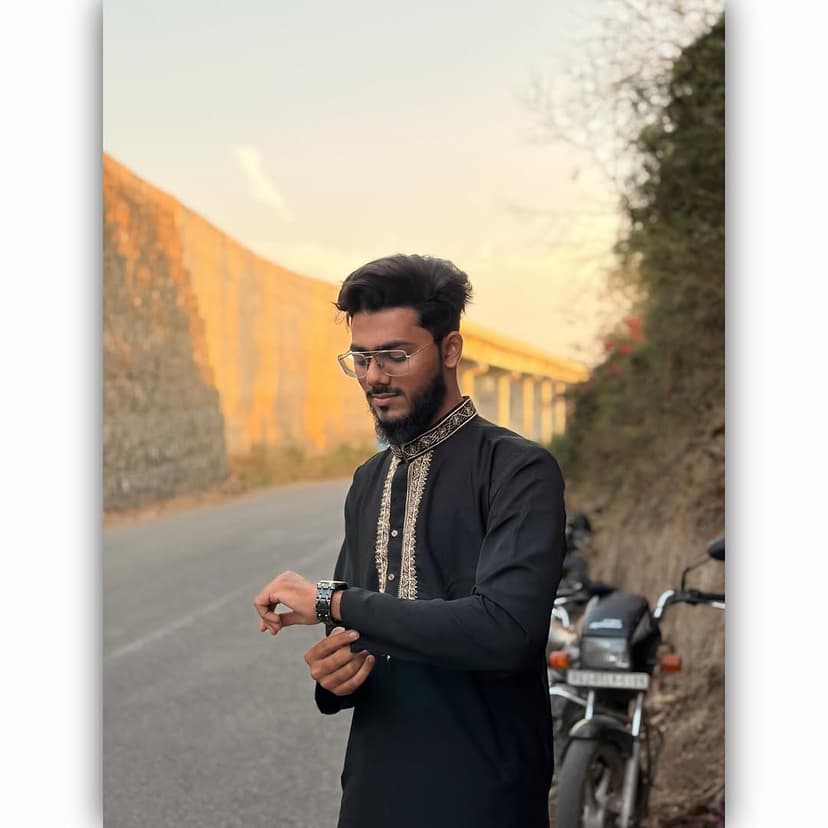 Umer Saiyad, Full Stack Developer from Surat, wearing a black traditional kurta and glasses outdoors by a road.
